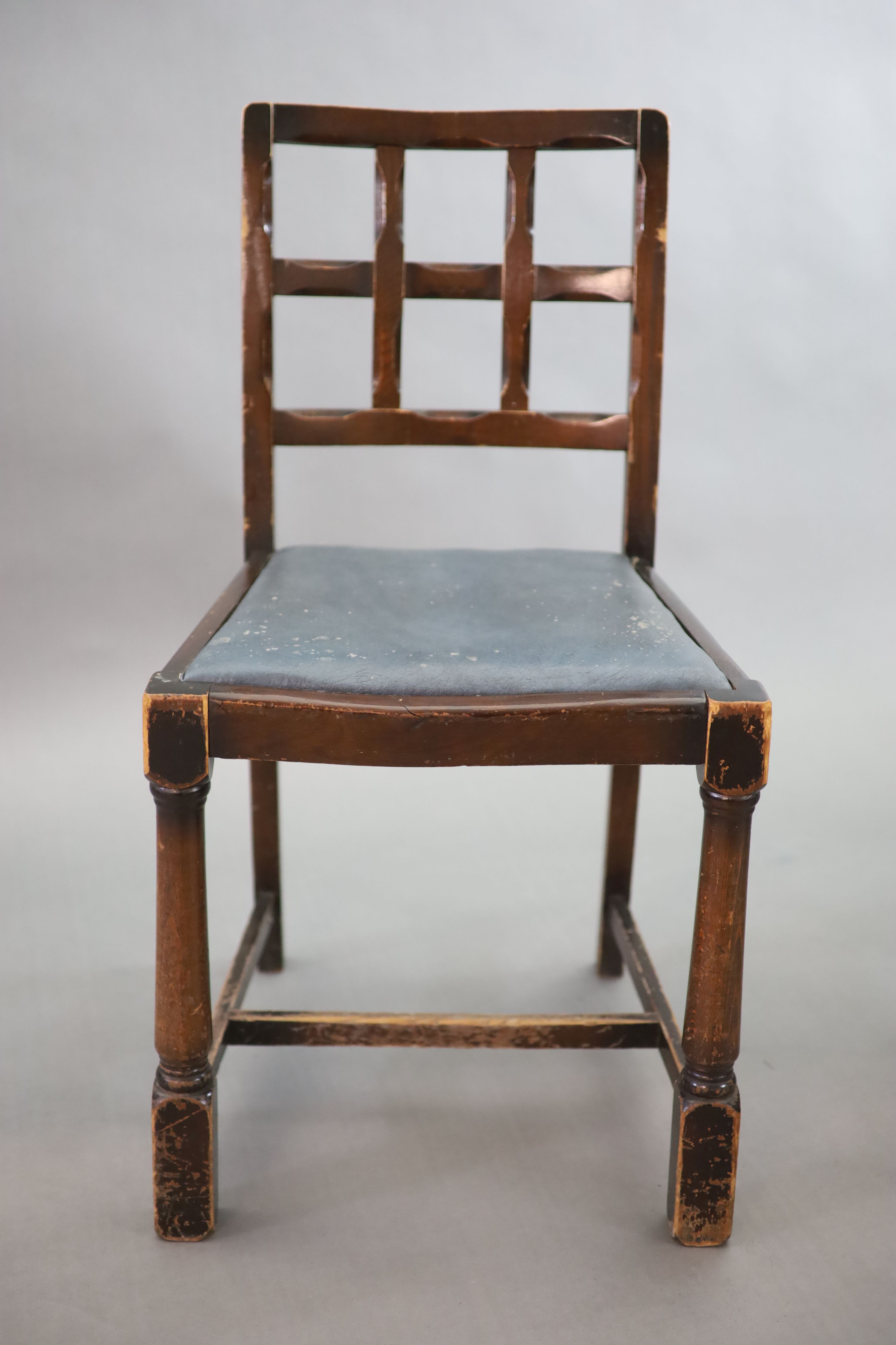 A set of twelve stained beech and oak dining chairs, with cross frame backs and drop-in seats, on turned and squared legs